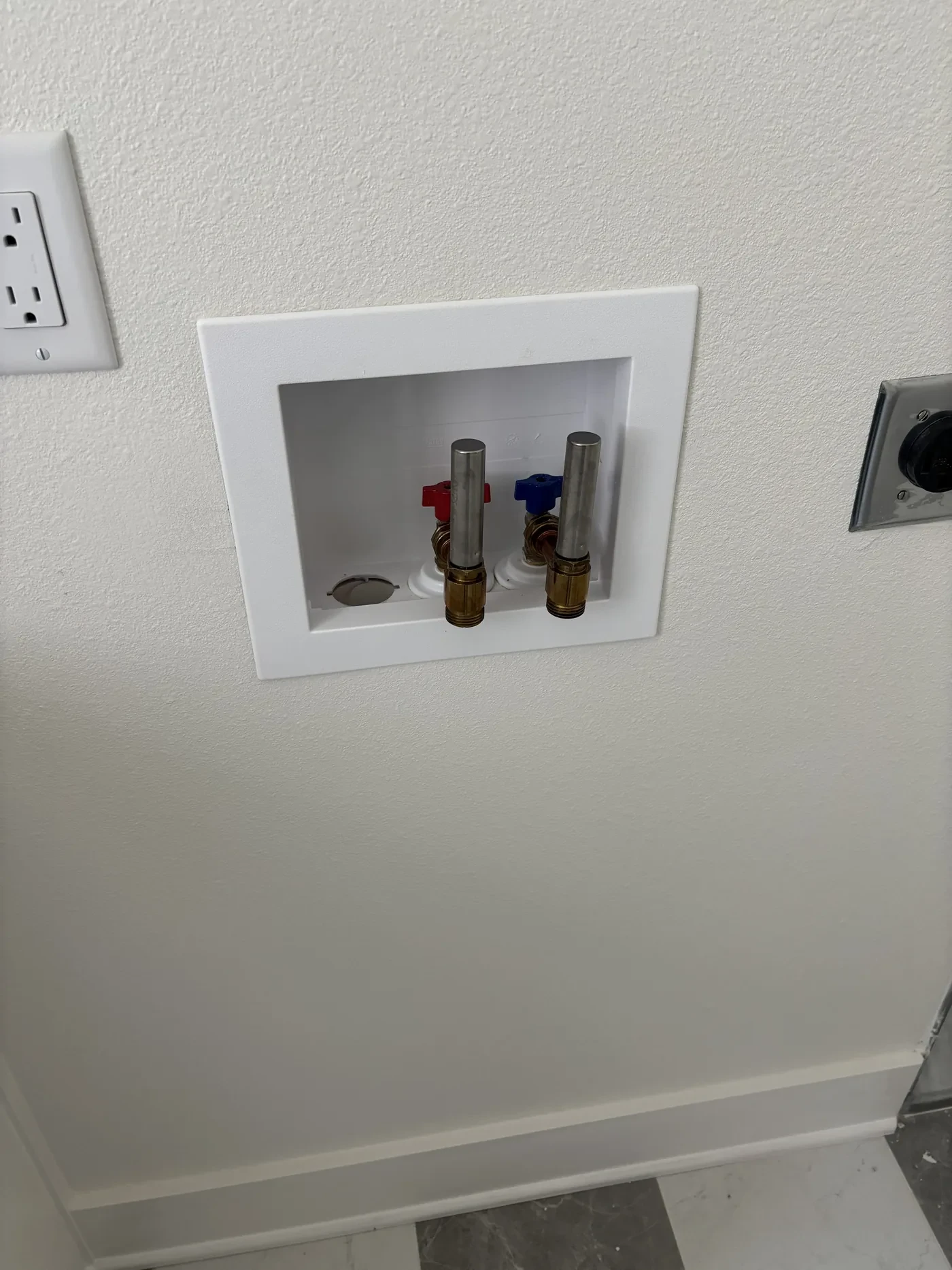 Washing machine outlet box with supply valves on Club Drive in Tyler, Texas