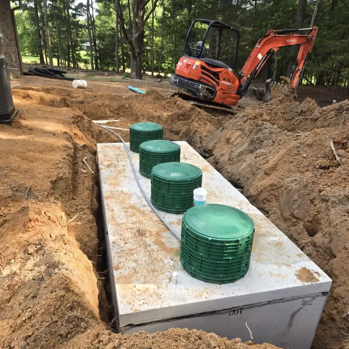 Septic tank installation with excavator in East Texas