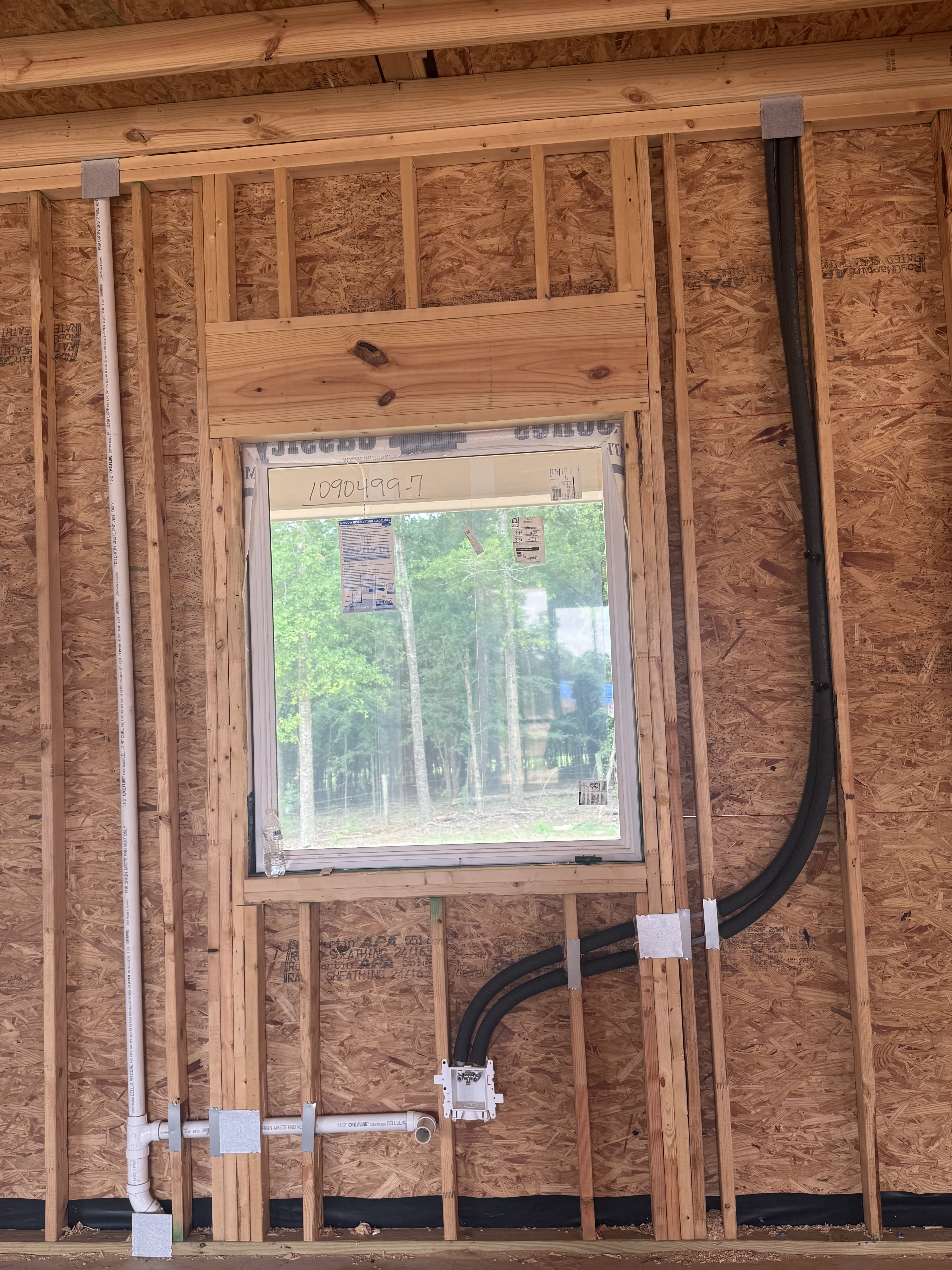 Wall rough-in with drain and vent piping at the Gresham job site