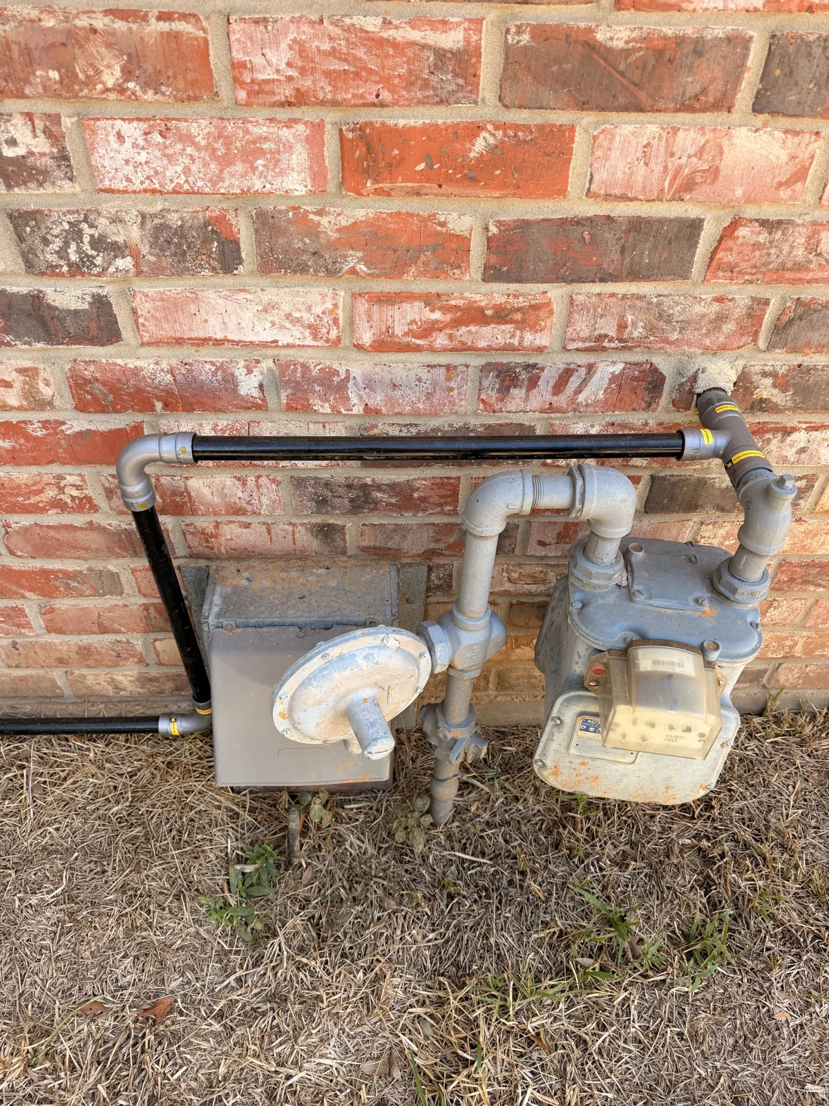 New black iron gas line leaving the meter and regulator on Royal Oaks in Hollytree, Tyler TX