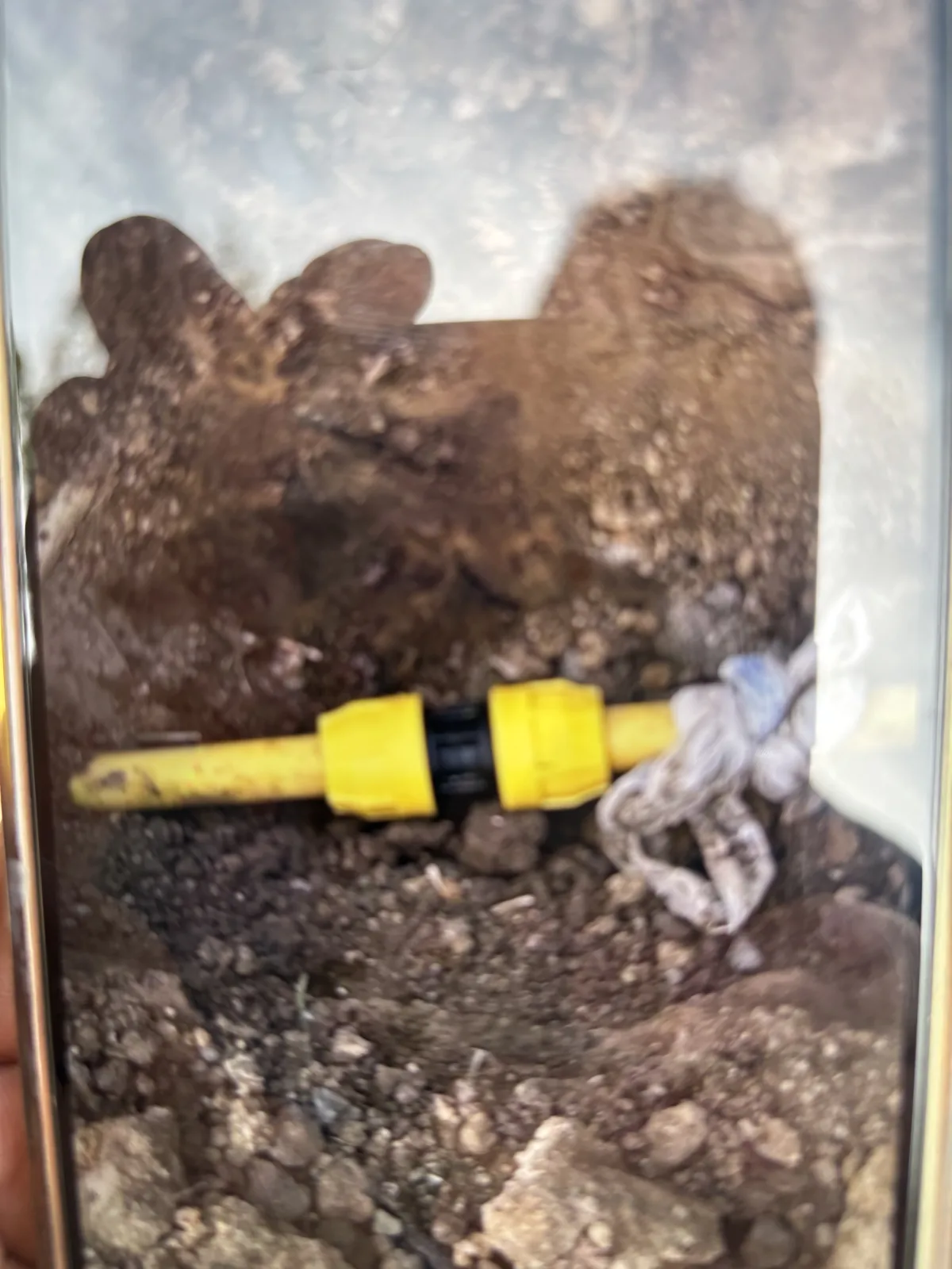 Yellow polyethylene gas line coupling in a repair trench on Gleneagles Drive in Hollytree, Tyler TX