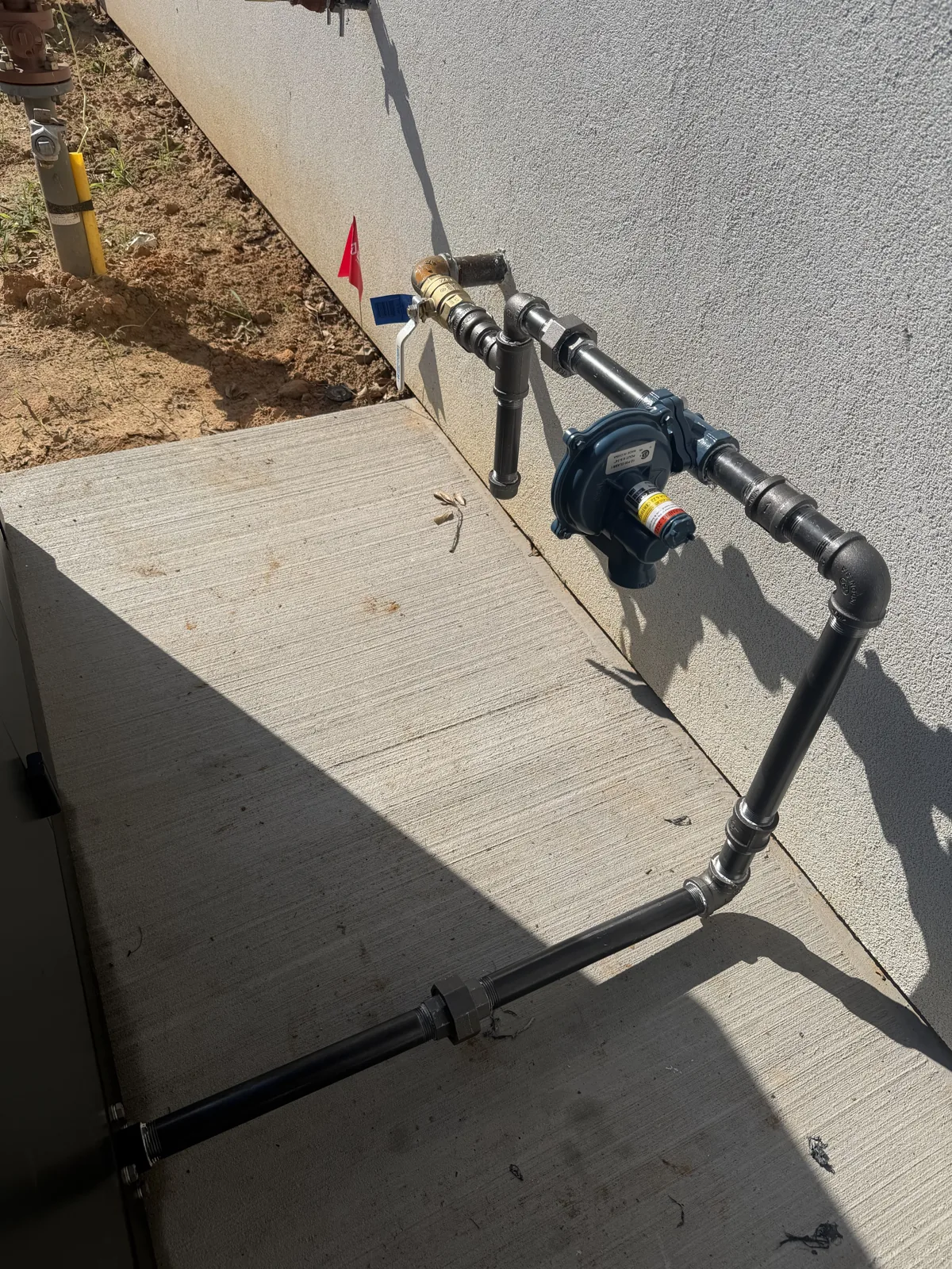 Exterior black iron gas line with regulator on Hollytree Drive in Tyler TX