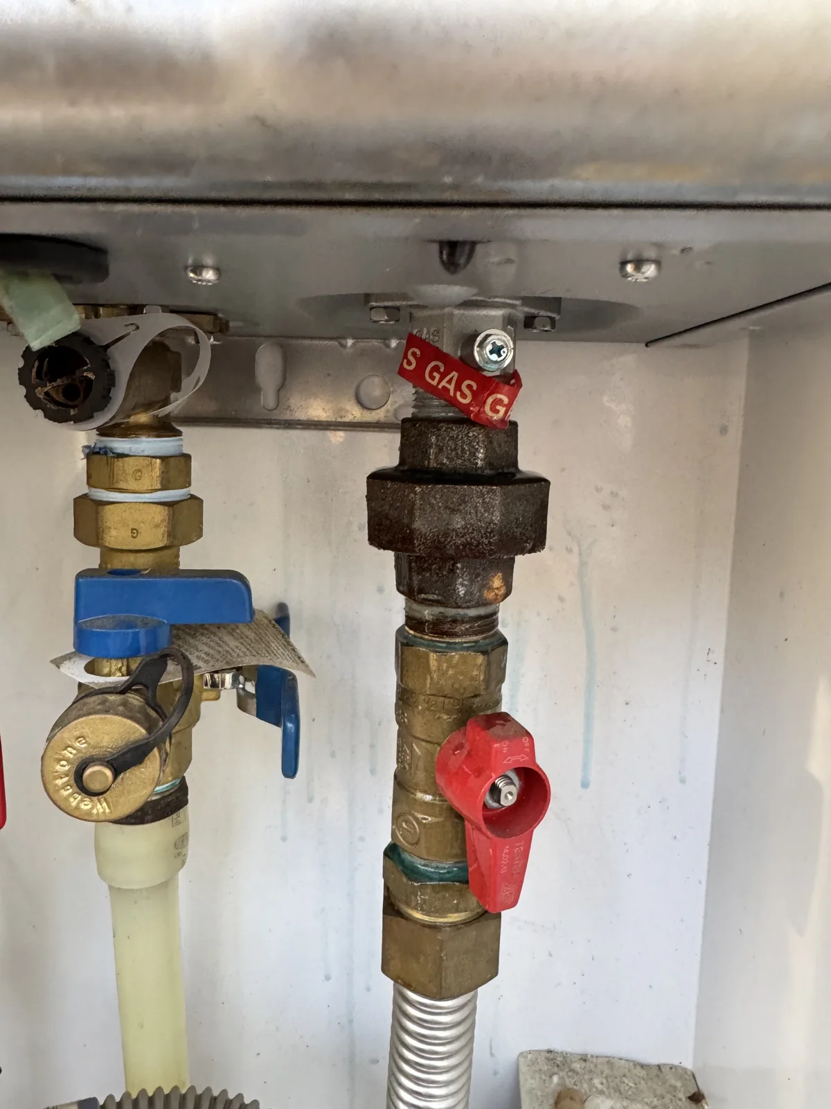 Gas and water valves under a tankless water heater on Oak Hills Boulevard, Tyler TX, about 0.2 miles from The Highlands